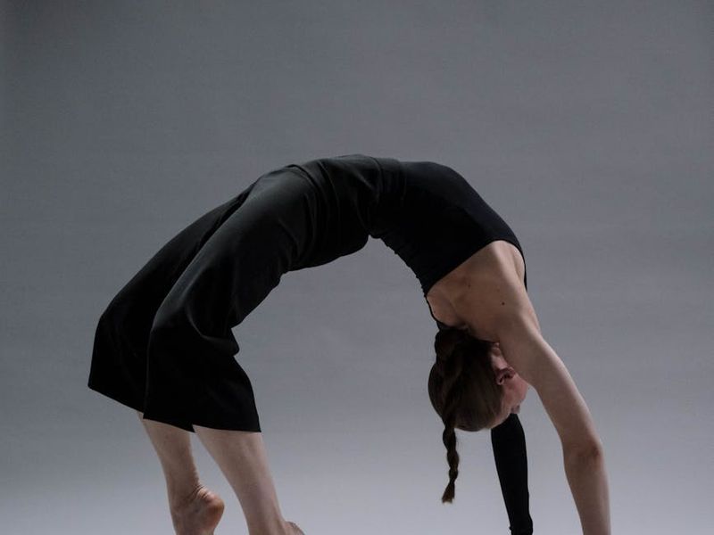 Person practicing yoga in a dark aesthetic environment