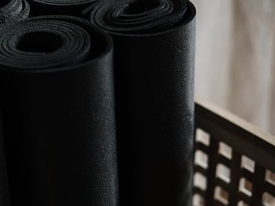 Yoga wooden blocks and a rolled mat